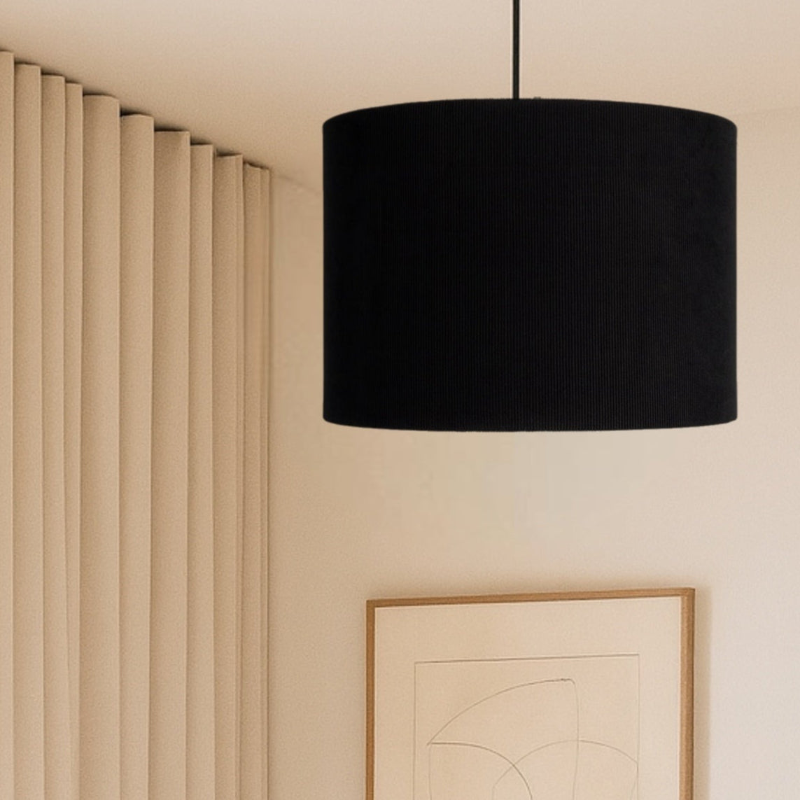 Modern bedroom with a black pendant lamp, abstract wall art, and a white bed.