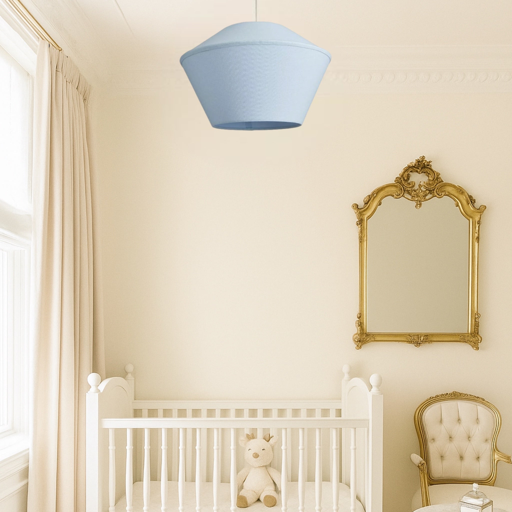 Nursery room with white crib, gold mirror, and blue pendant light.