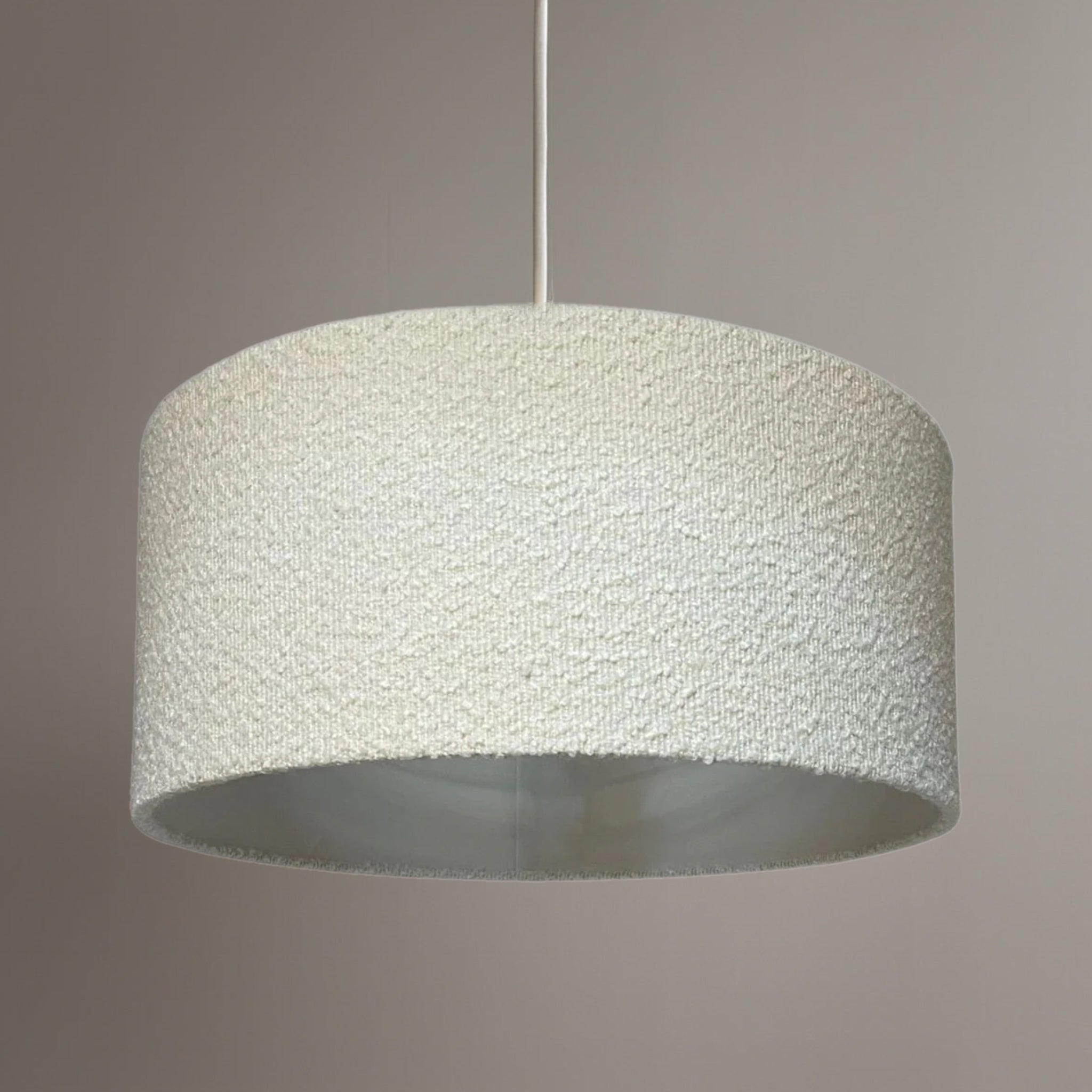 Textured pendant light on a neutral background