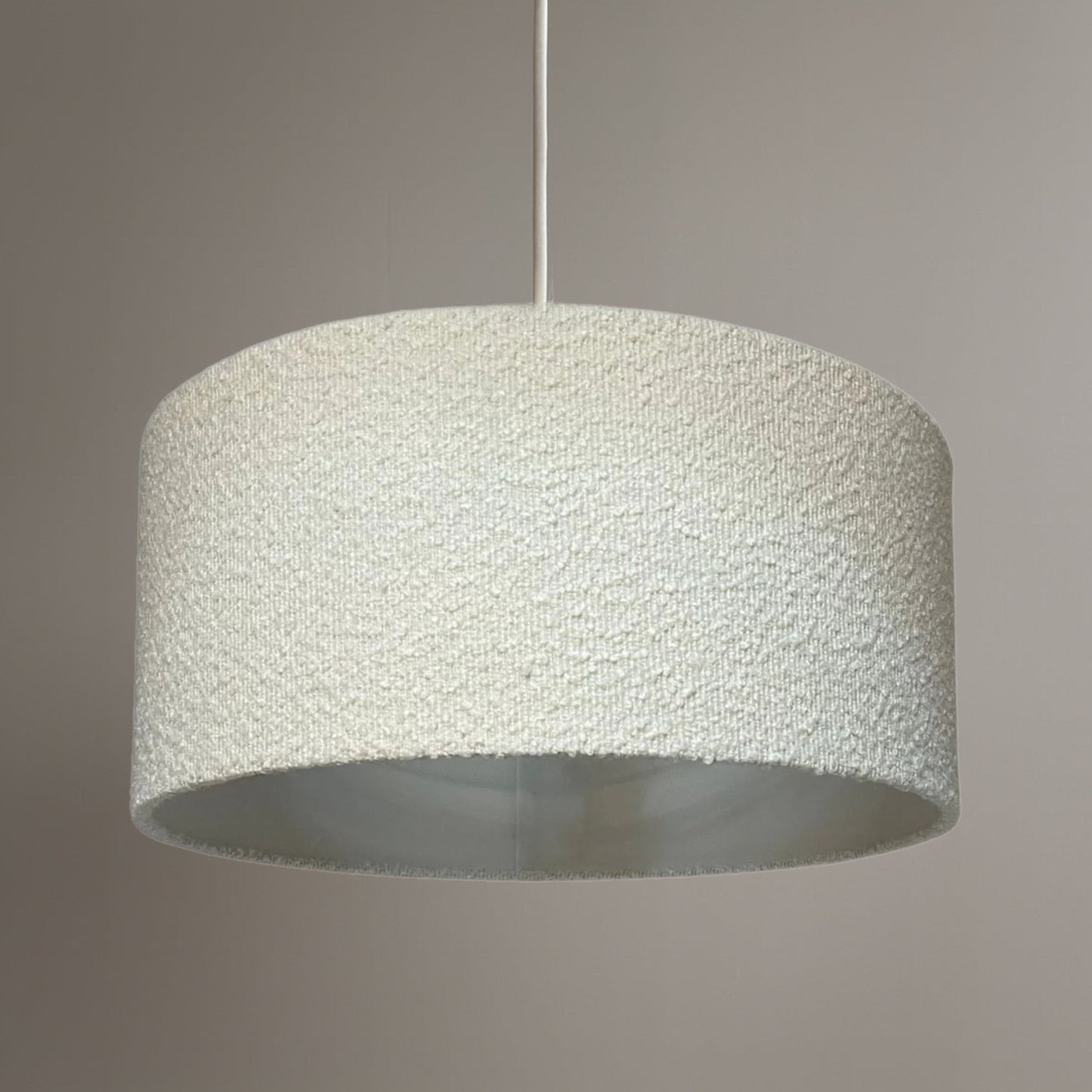 Textured pendant light on a neutral background