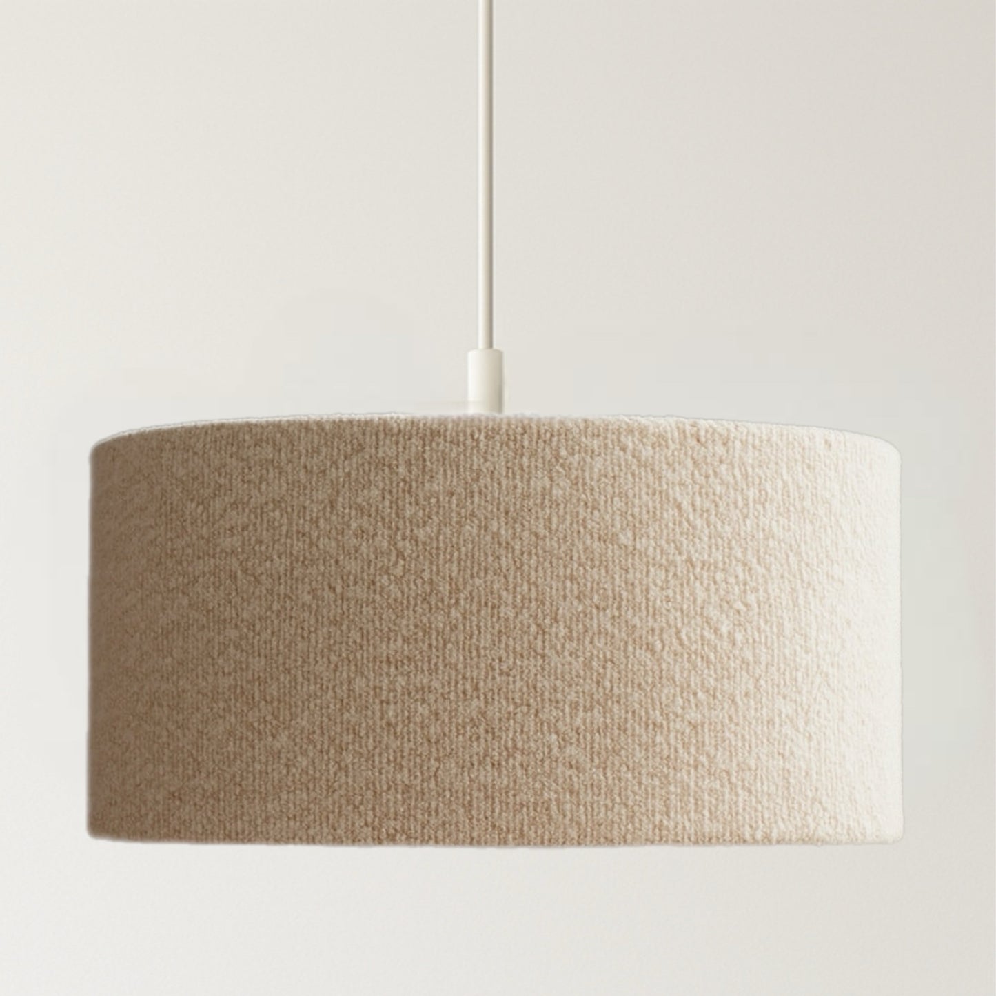 Textured beige pendant lamp on a plain background