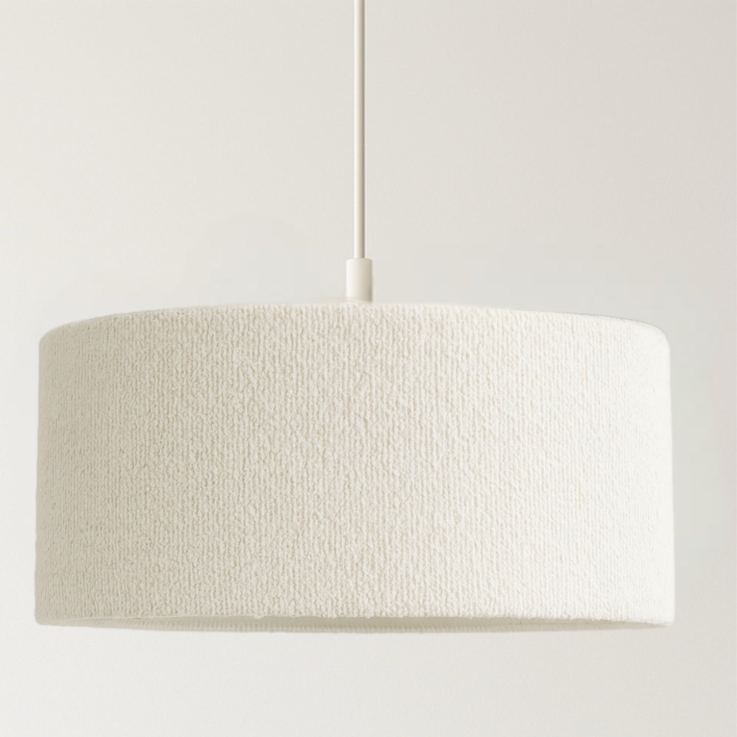 Textured beige pendant light on a white background