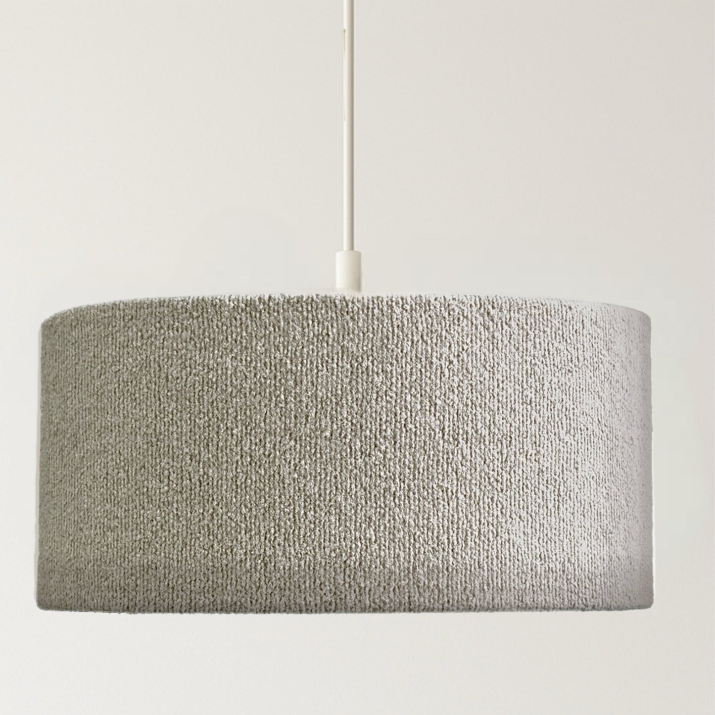 Textured gray pendant light on a neutral background