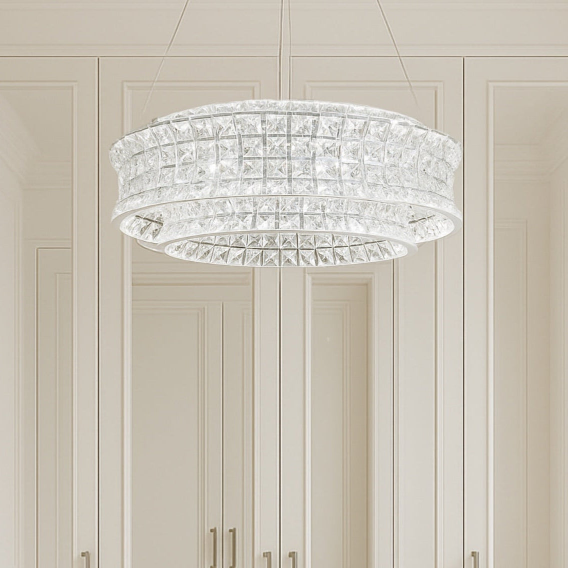 Modern interior with a crystal chandelier, vanity table, and chair.