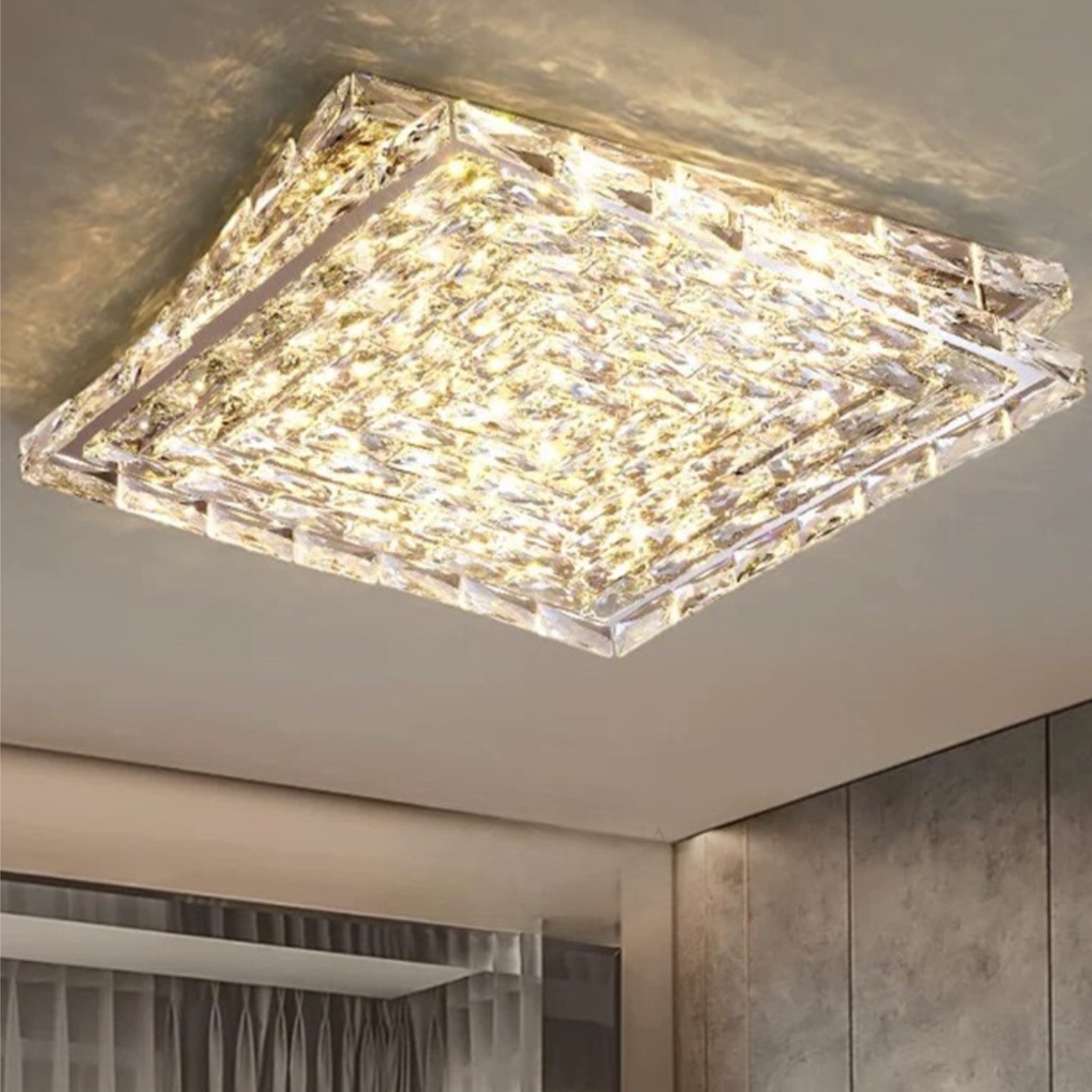 Introducing our Harmony ceiling light with its elegant crystal and golden finish it will be sure to make a stylish addition to any living space. It features an ornate cut glass crystal design encasing the entire light fitting and is complimented by a gold back plate that gives the light an undeniably luxurious style. Ceiling lamps don't come much more opulent than the Harmony ceiling light.