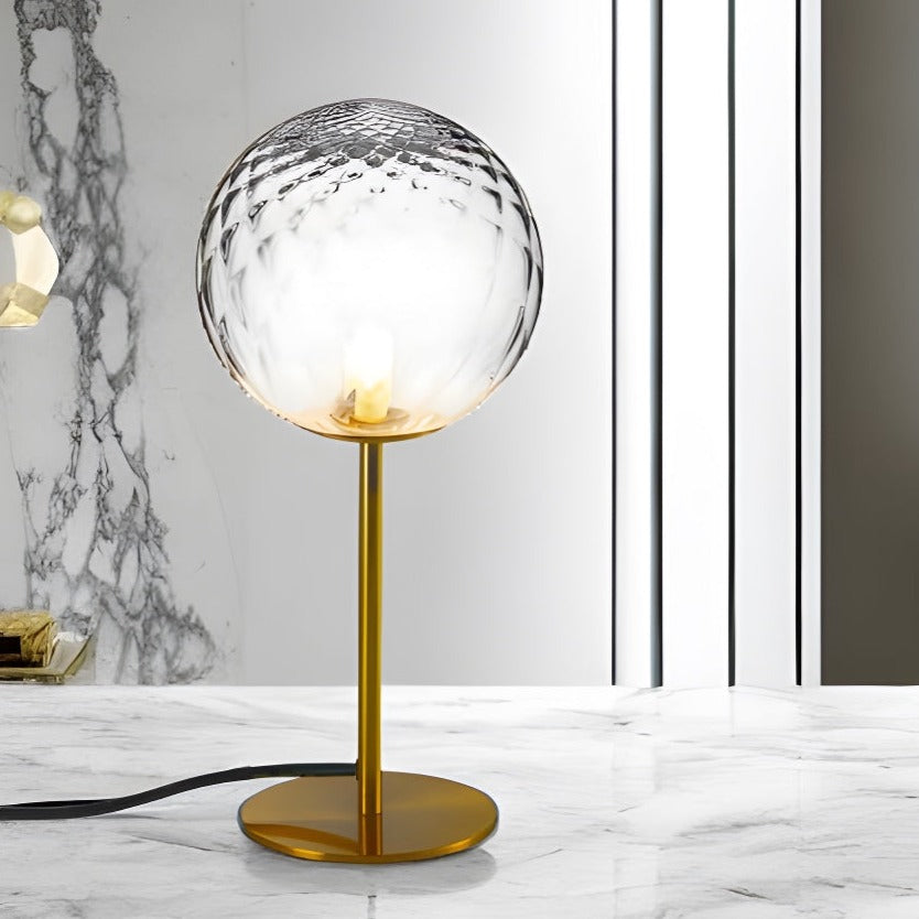 Introducing our Dixon table lamp with its elegant crystal and golden finish it will be sure to make a stylish addition to any living space. It features an ornate cut glass crystal globe design and is complimented by a brushed gold base that gives the light an undeniably luxurious style.