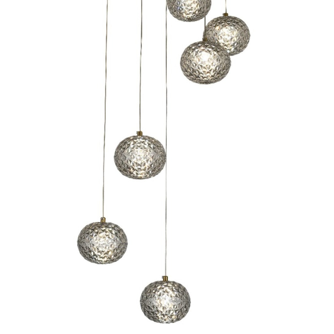 Our striking 6 Ball LED pendant light in gold with height adjustable smoked acrylic globes is the perfect way to make a statement with your interiors. It is inspired by elements of the night sky, comprising of a delicately crafted smoked acrylic crystal globes in round spherical shape and perfectly finished in low energy built in LED lights.
