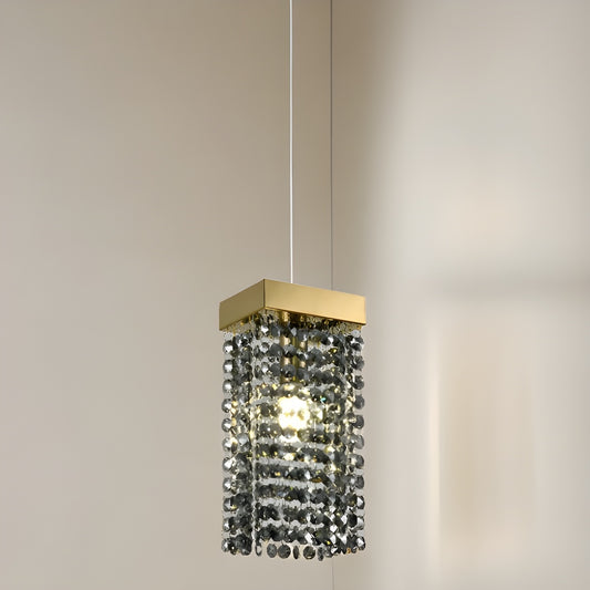 Our striking Astley pendant light in gold with smoked crystals is the perfect way to make a statement with your interiors. With its modern design, comprising of a delicately crafted smoked acrylic crystals in a hanging style from a gold rectangle base this light is the perfect addition to any space in your home.