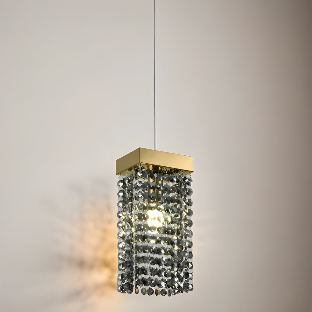 Our striking Astley pendant light in gold with smoked crystals is the perfect way to make a statement with your interiors. With its modern design, comprising of a delicately crafted smoked acrylic crystals in a hanging style from a gold rectangle base this light is the perfect addition to any space in your home.