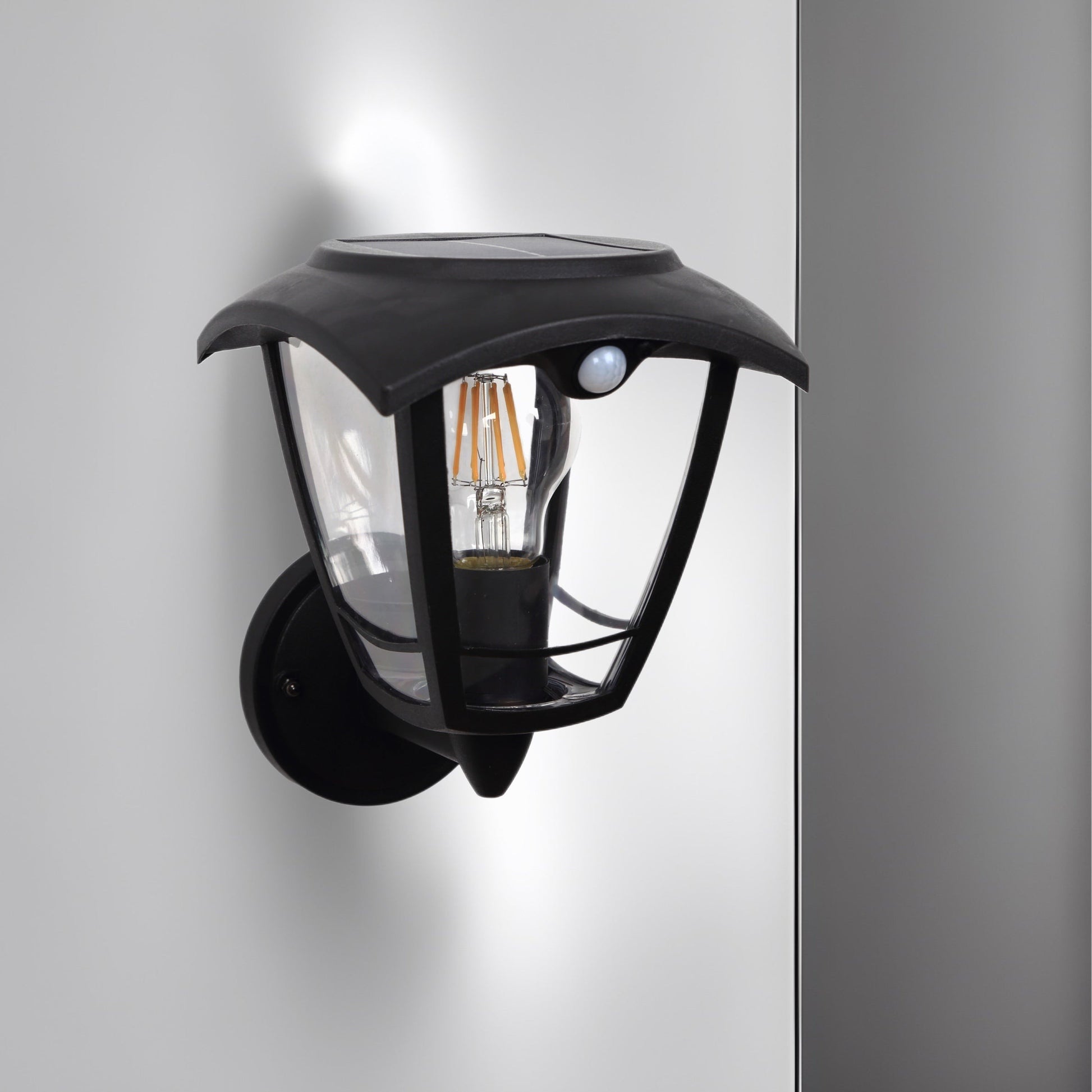 Create an aesthetically pleasing lighting system around your home with our Lara solar lantern light for your walls. This product is featured as an elegant and traditional lantern wall light design, constructed from black polycarbonate and fitted with clear polycarbonate diffusers. The Lara wall light comes complete with an integrated filament warm white LED bulb and integrated PIR motion sensor
