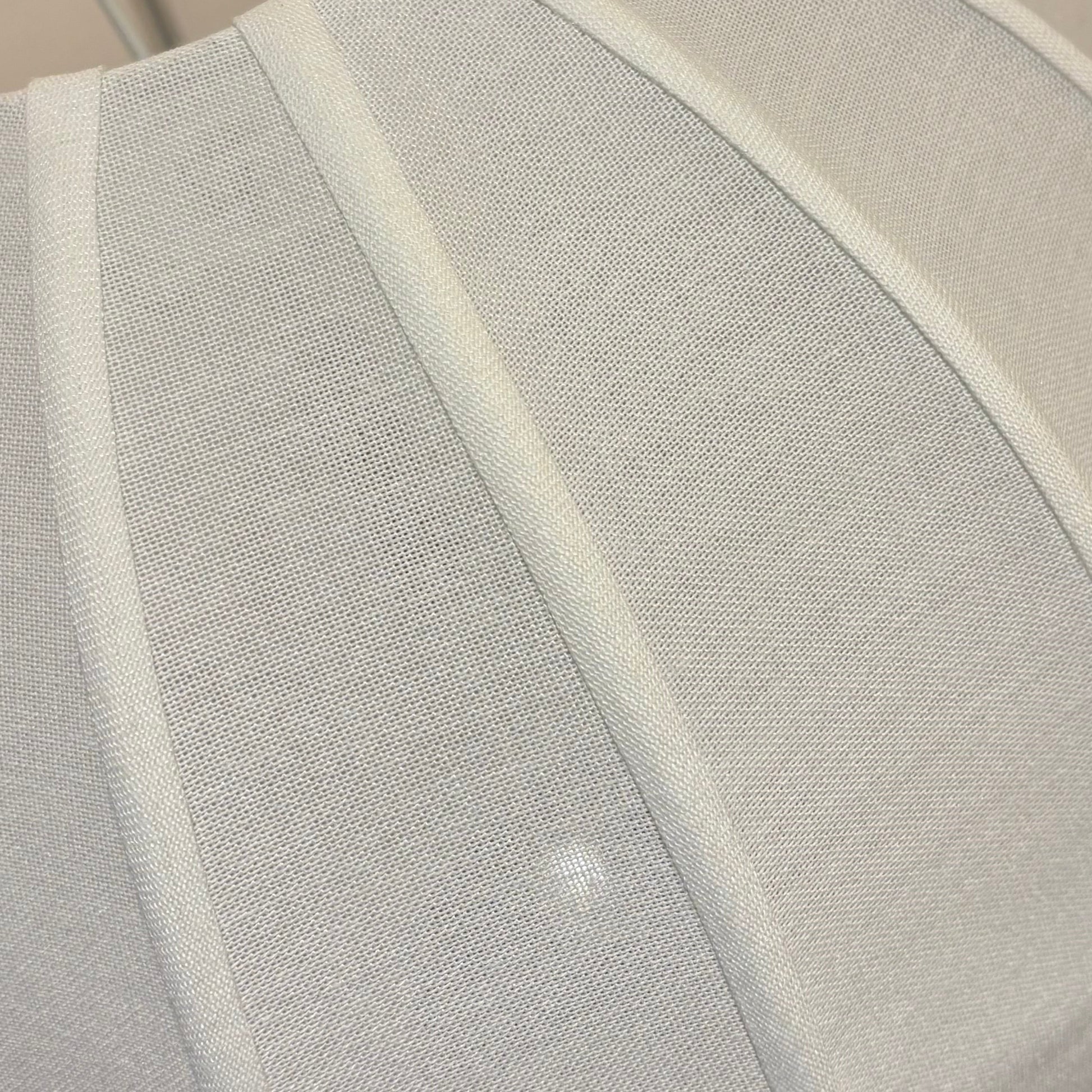 White cushion on a chair with a blurred background
