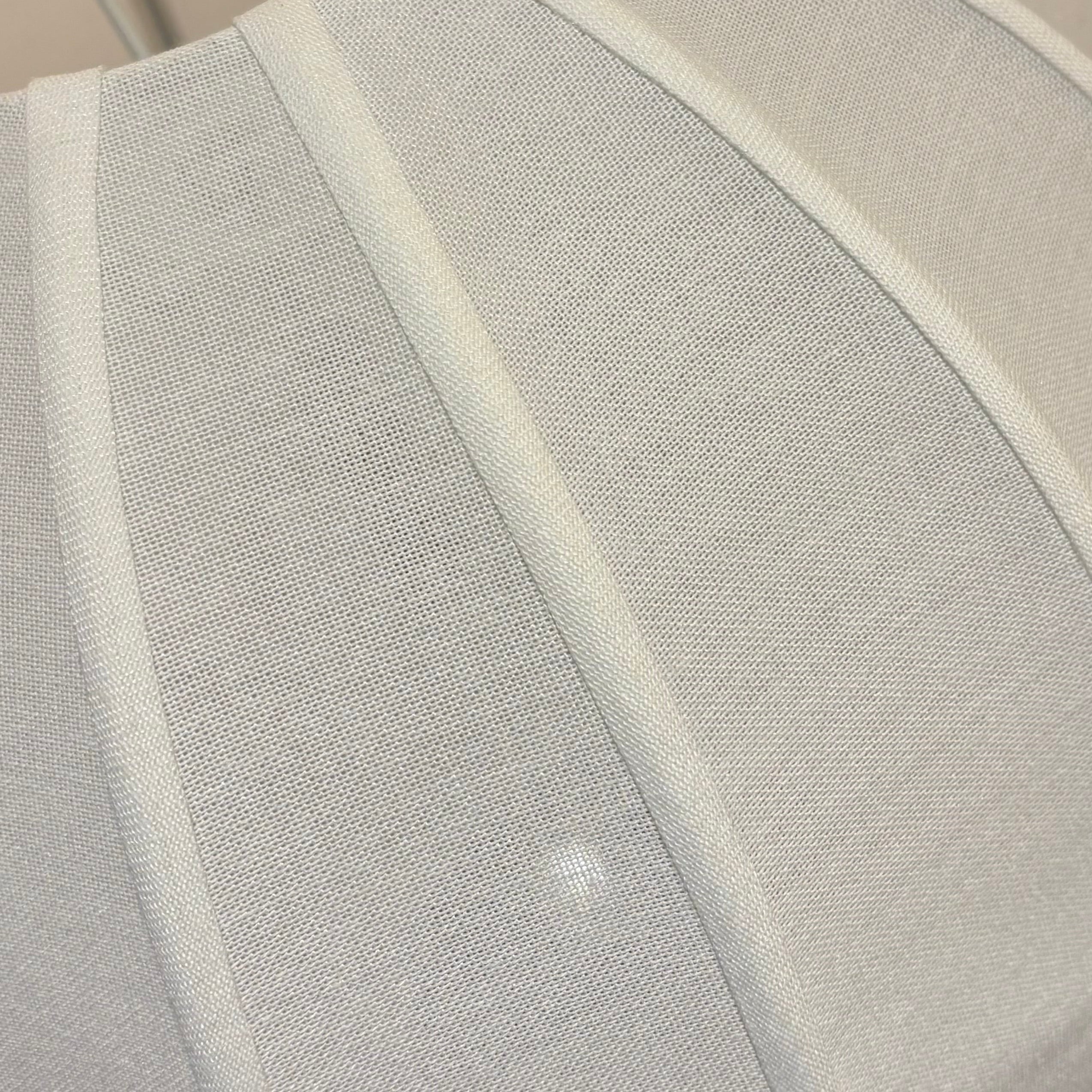 White cushion on a chair with a blurred background