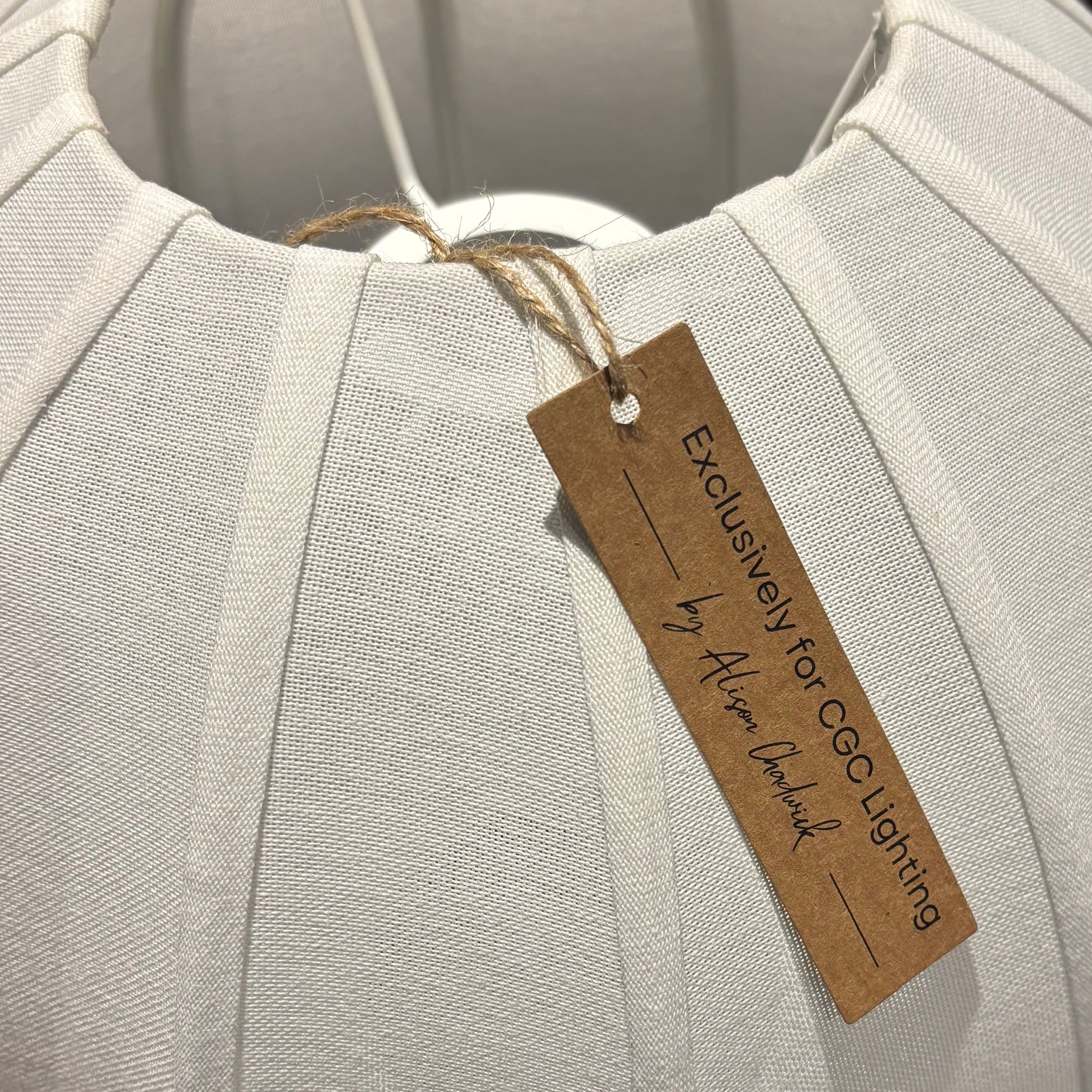 White fabric product with a brown tag on a blurred background