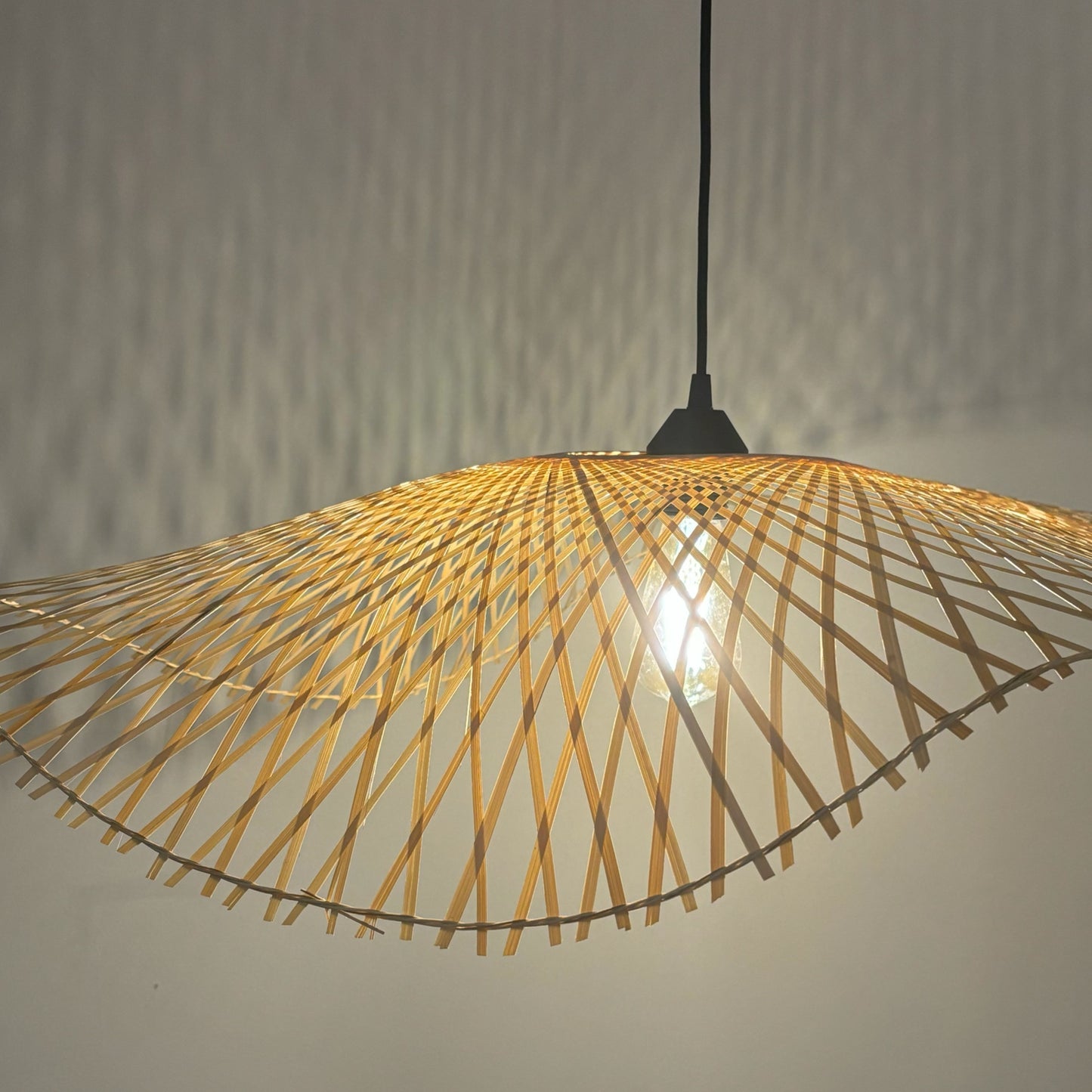 Enhance the ambiance of your room with the Tulul Bamboo Lamp Shade. Hand made of bamboo, a popular eco-friendly material, this lampshade boasts an elegant and unique design that adds a natural and refreshing touch to any room. Transform your space with Tulul and embrace a more sustainable lifestyle.