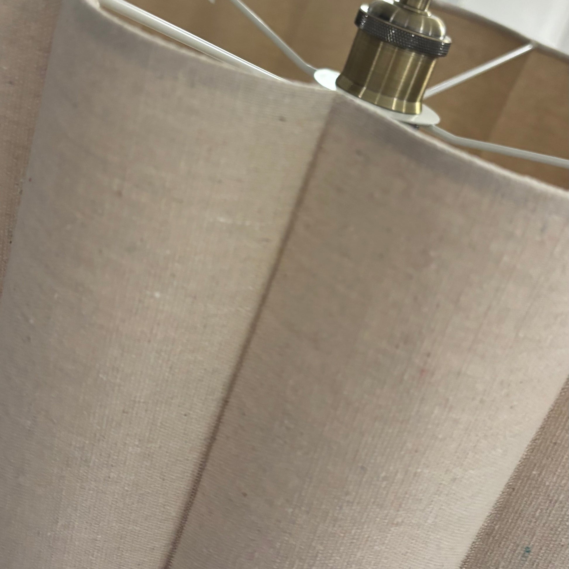 Close-up of a beige lampshade with a light fixture.