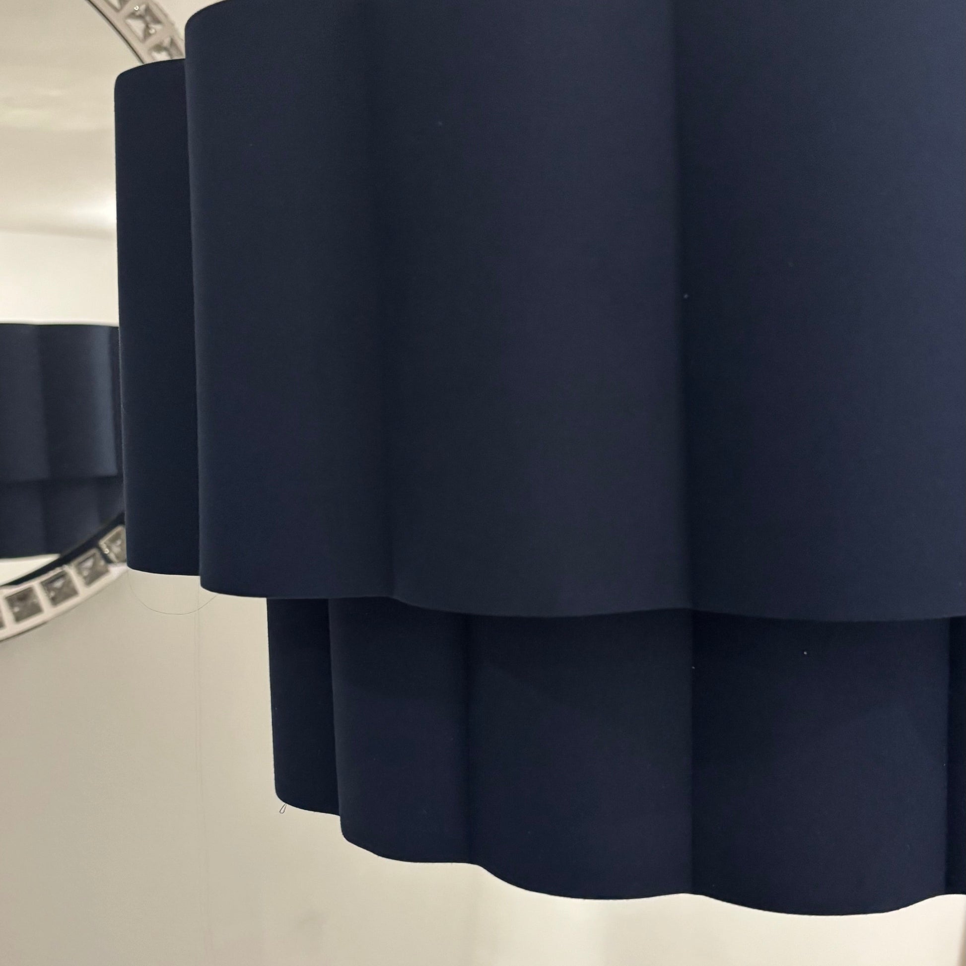 Navy blue lampshade on a white wall