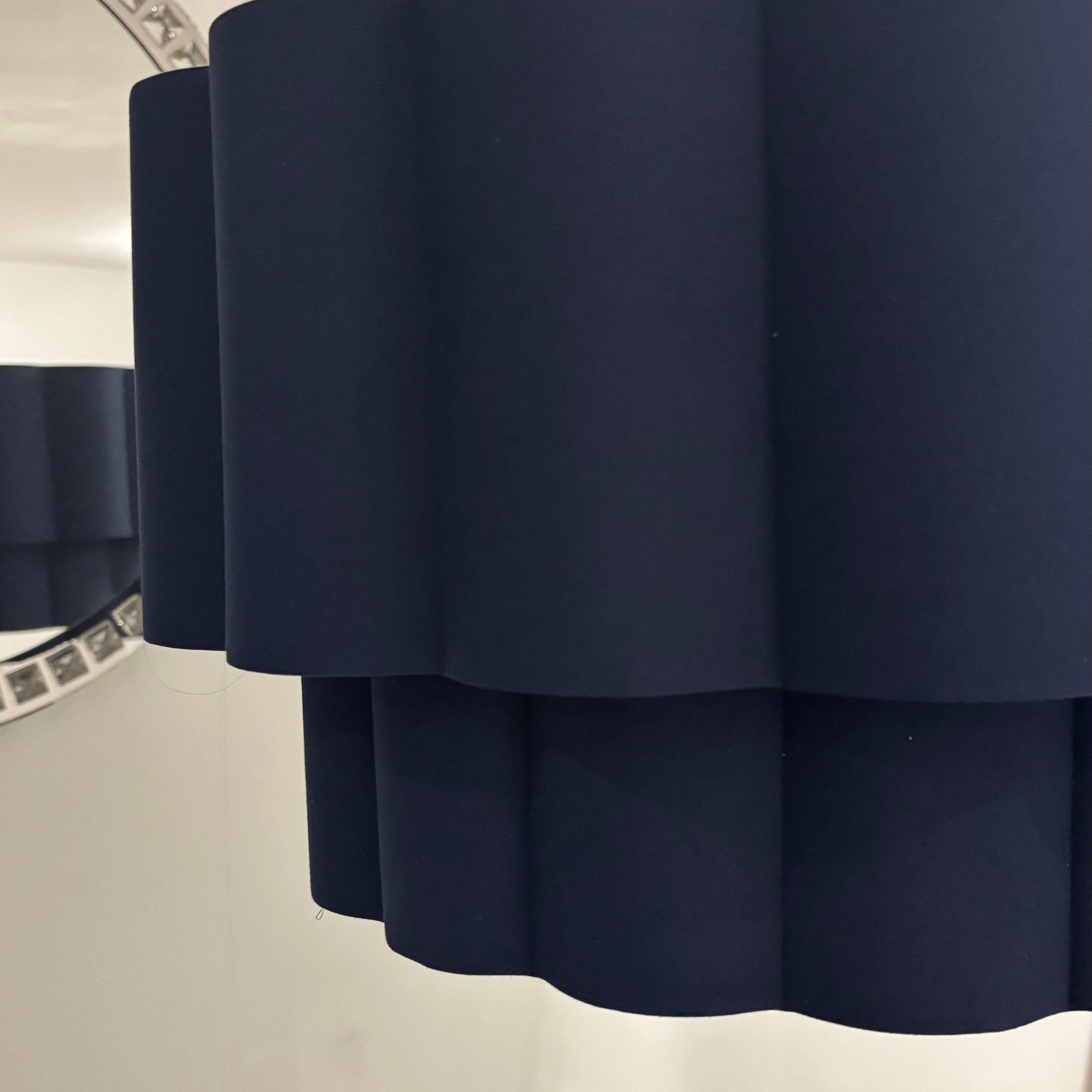 Navy blue lampshade on a white wall