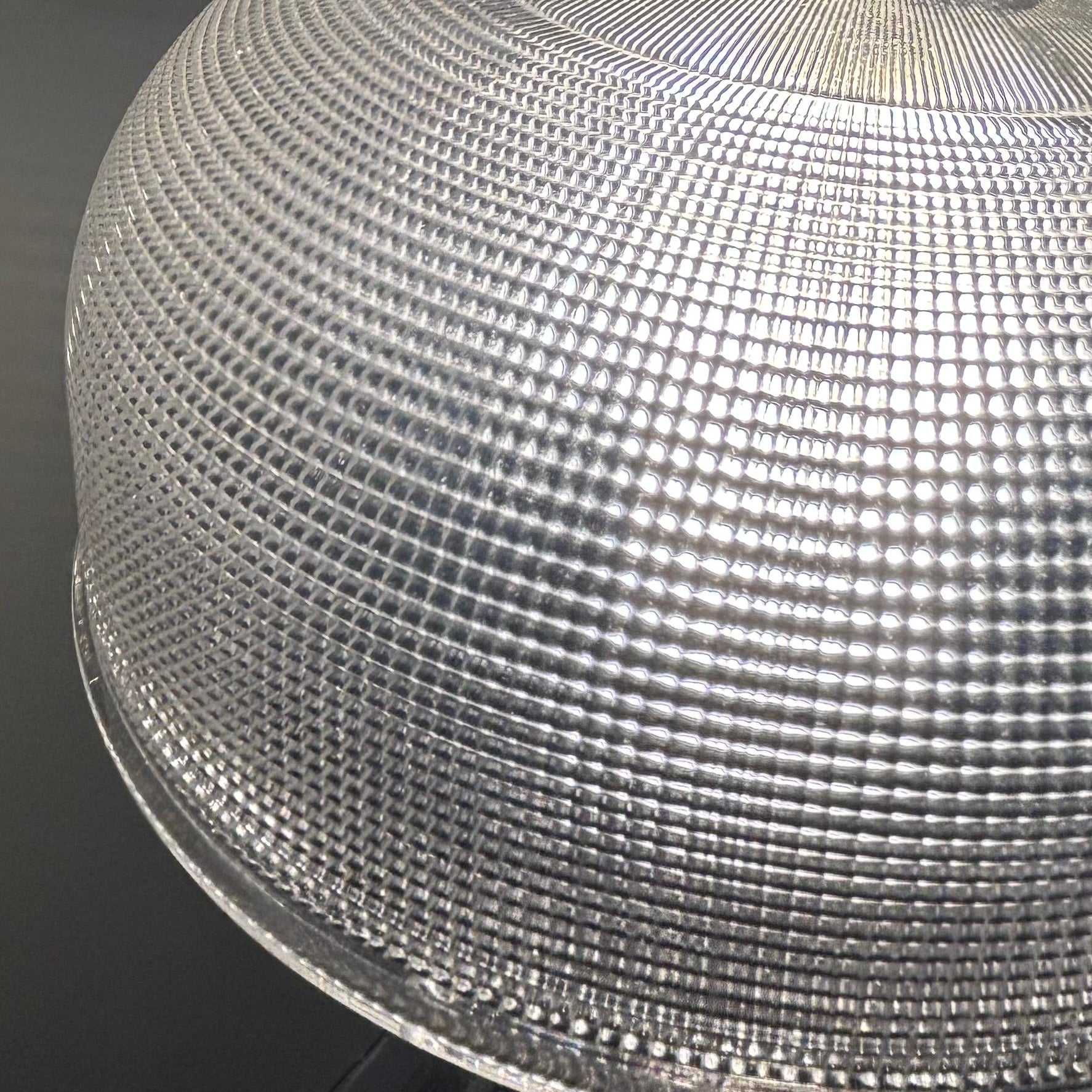 Close-up of a textured metallic surface with a dark background