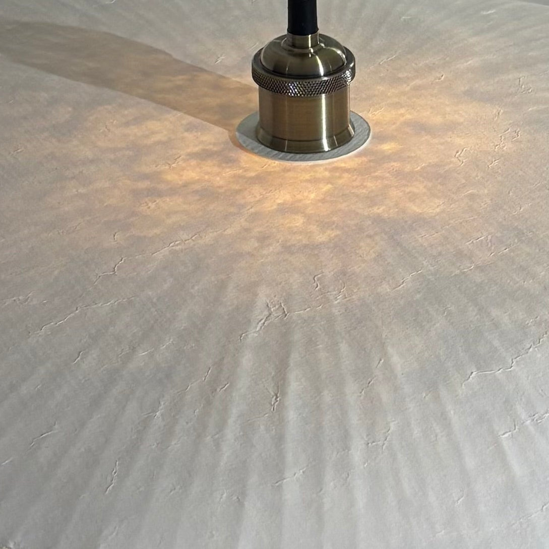 Close-up of a textured stone surface with a metallic object on top