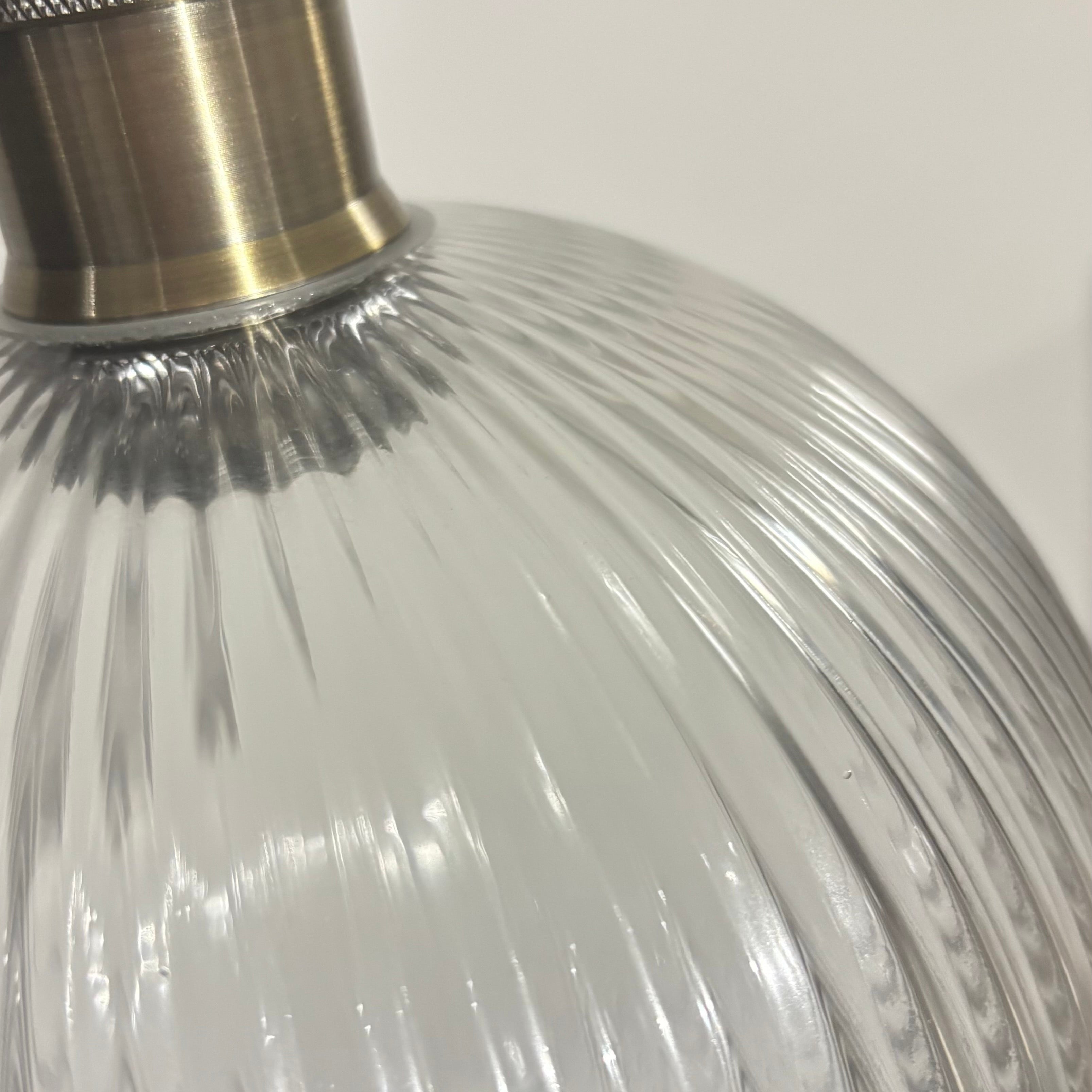 Close-up of a glass bottle with a metallic cap on a white background