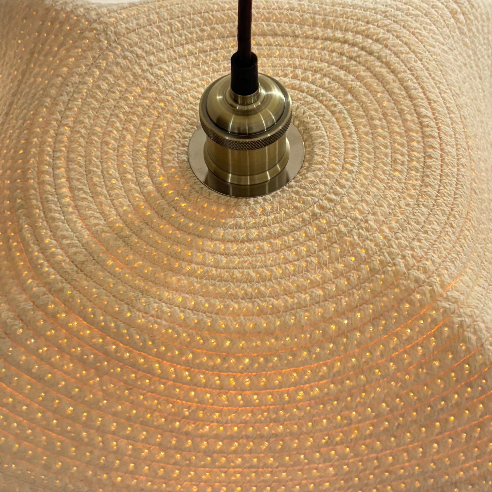 Close-up of a textured lampshade with a metallic fixture