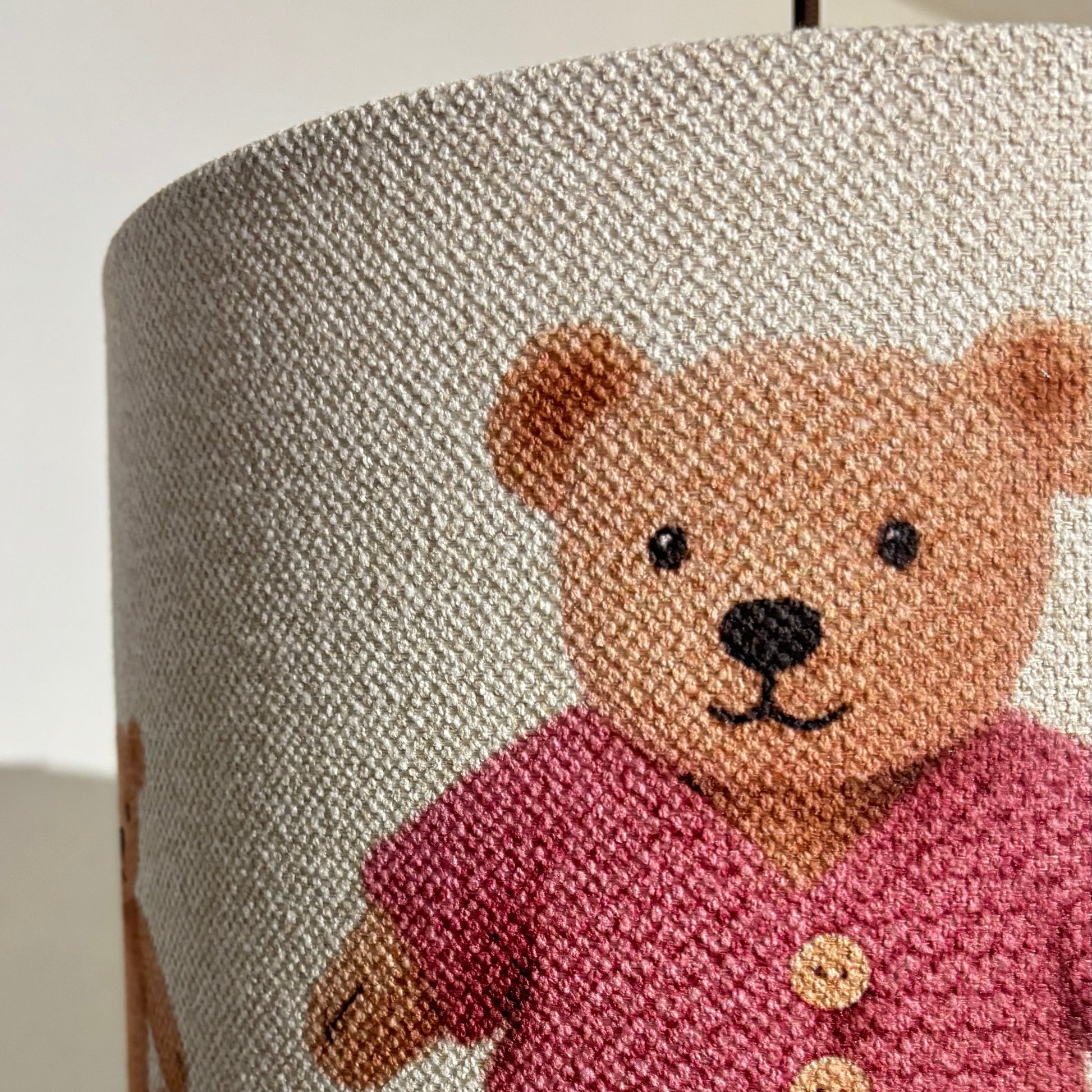 Lampshade with a teddy bear design on a plain background