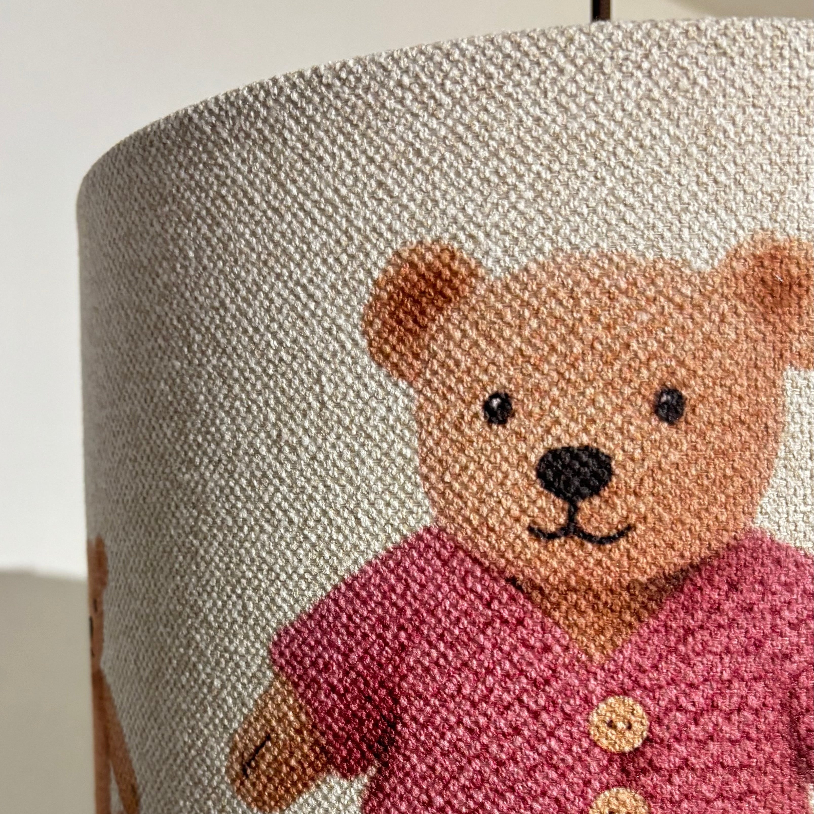 Lampshade with a teddy bear design on a plain background