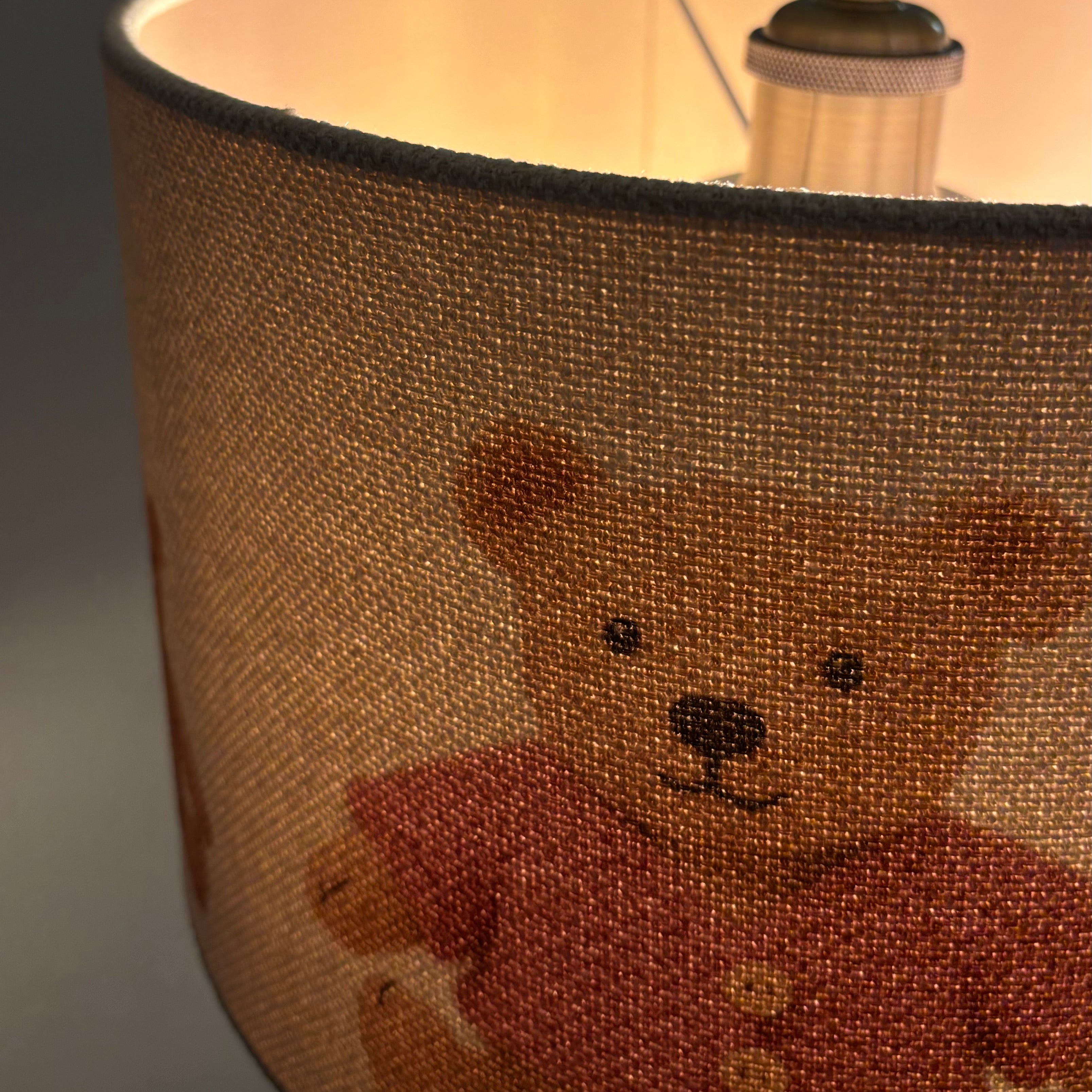 Lampshade with a teddy bear design on a neutral background