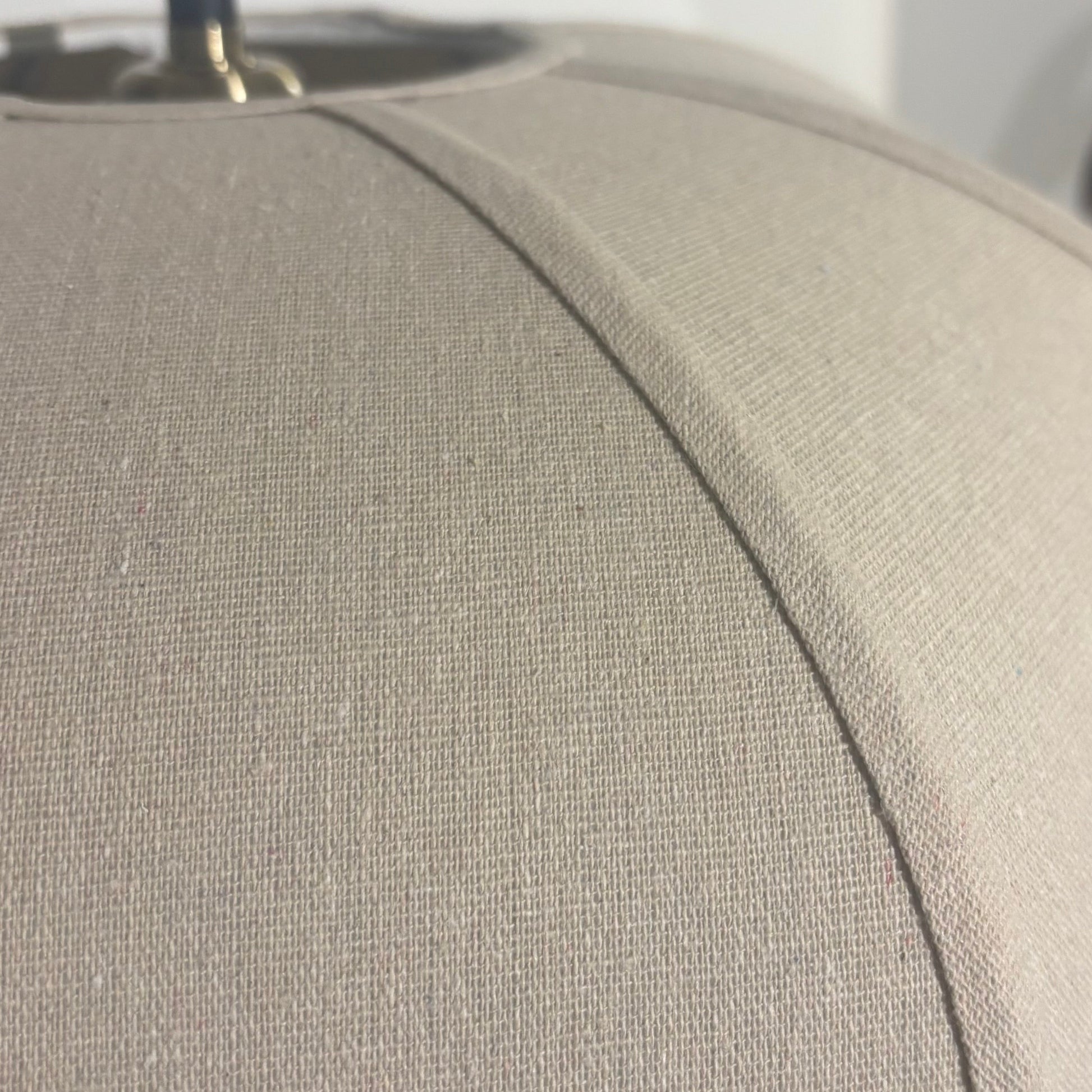 Close-up of a beige fabric surface with a blurred background