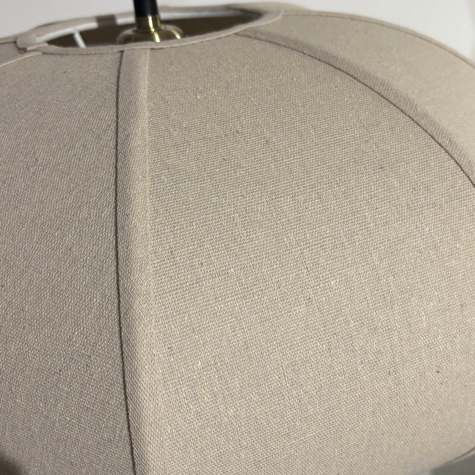 Close-up of a beige lampshade with a blurred background