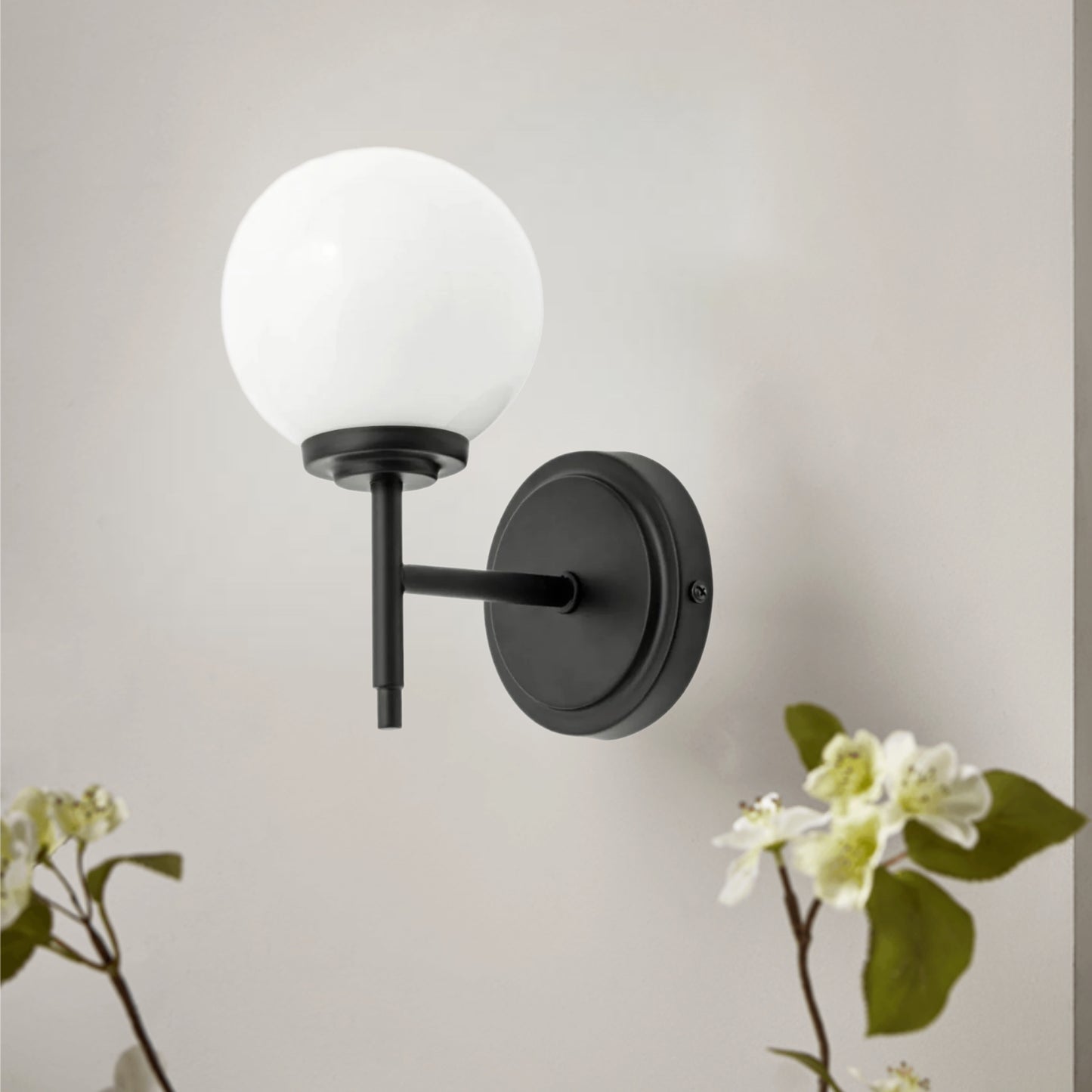 Our Marley globe armed wall light is a stylish light fitting ideal for the modern home and can be used in the bathroom. It features a matt black effect round ceiling plate and a globe opal glass shade mounted on a black arm.