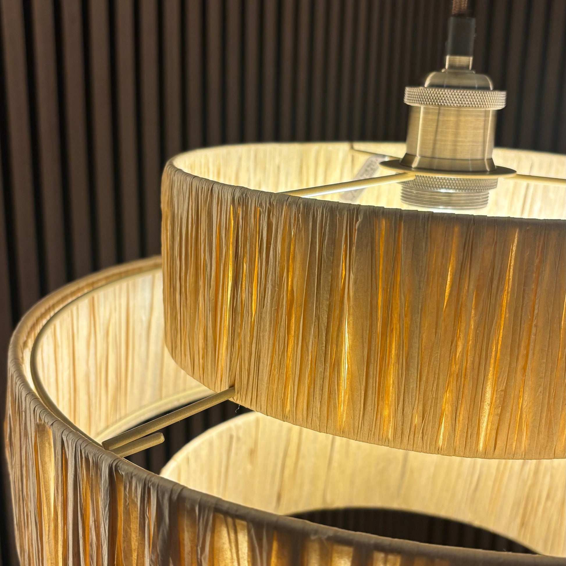 Close-up of a gold fringed lampshade with a blurred background