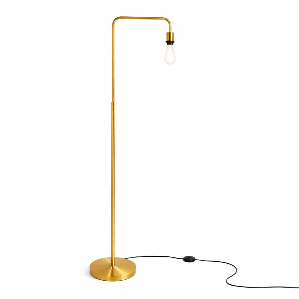 Gold floor lamp with a single bulb on a white background