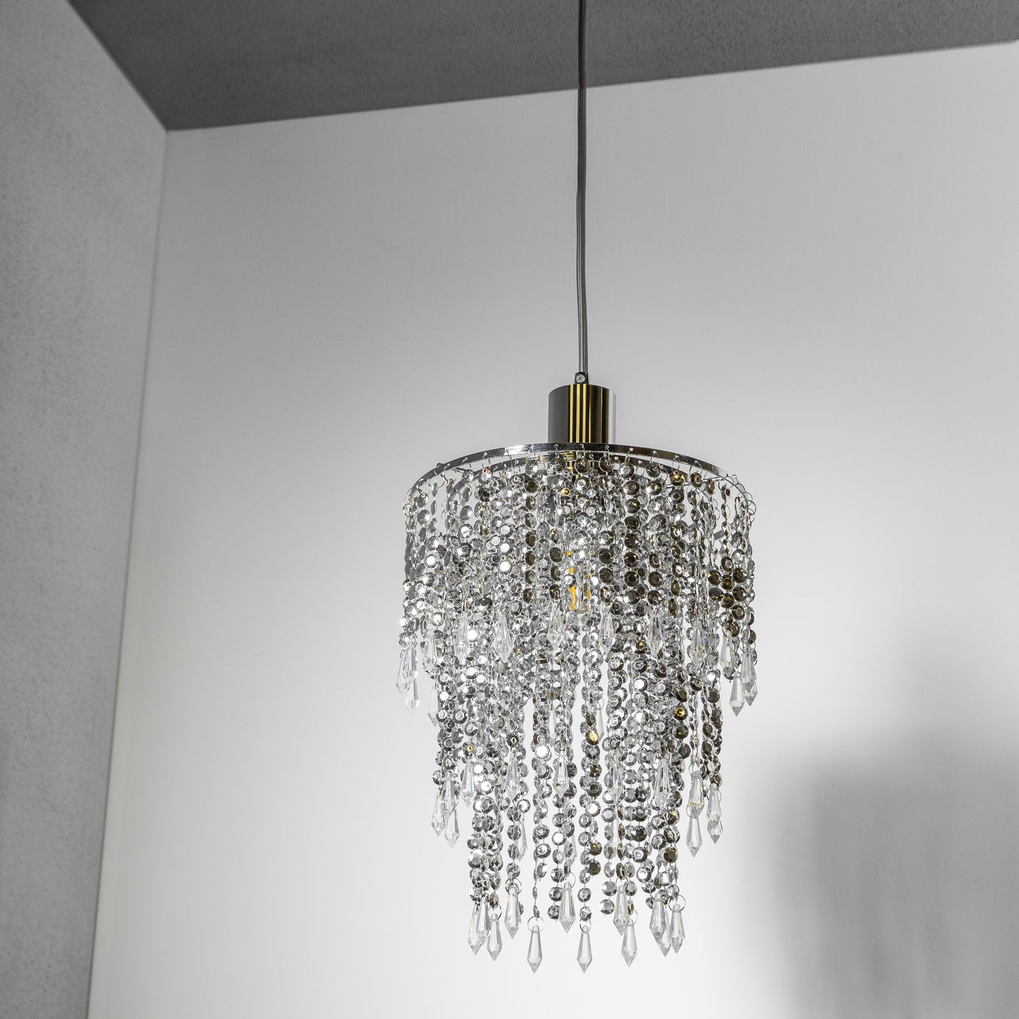 Our Liza easy fit ceiling pendant shade features polished chrome circular rings with varying lengths of acrylic crystal strands. This beautiful easy fit pendant shade will add glamour to any space whilst instantly updating your room without the need of an electrician. 