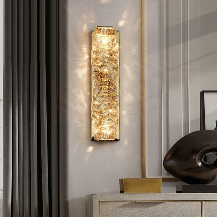  Introducing our Regency wall light with its elegant styling and golden finish it will be sure to make a stylish addition to any living space.  It features an ornate cut glass crystal in twisted design cascading down the entire light fitting and is complimented by a gold back plate that gives the light an undeniably luxurious style. The crystals hark back to classical design trends, whilst the gold finishes the piece with a more contemporary and even minimalistic twist ideal for any home.