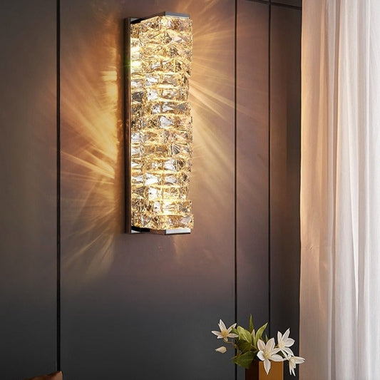  Introducing our Regency wall light with its elegant styling and golden finish it will be sure to make a stylish addition to any living space.  It features an ornate cut glass crystal in twisted design cascading down the entire light fitting and is complimented by a gold back plate that gives the light an undeniably luxurious style. The crystals hark back to classical design trends, whilst the gold finishes the piece with a more contemporary and even minimalistic twist ideal for any home.