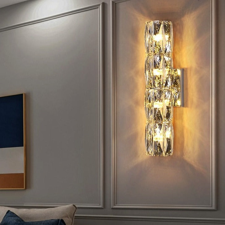 Introducing our Caspian wall light with its elegant styling and golden finish it will be sure to make a stylish addition to any living space. It features an ornate cut glass crystal design encasing the entire light fitting and is complimented by a gold back plate that gives the light an undeniably luxurious style. The crystals hark back to classical design trends, whilst the gold finishes the piece with a more contemporary and even minimalistic twist ideal for any home.