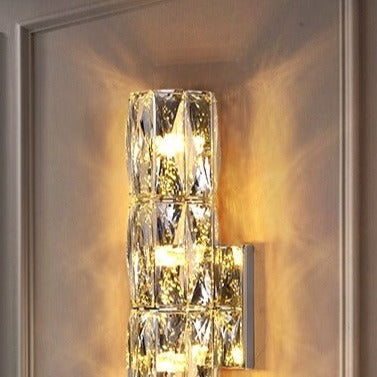 Introducing our Caspian wall light with its elegant styling and golden finish it will be sure to make a stylish addition to any living space. It features an ornate cut glass crystal design encasing the entire light fitting and is complimented by a gold back plate that gives the light an undeniably luxurious style. The crystals hark back to classical design trends, whilst the gold finishes the piece with a more contemporary and even minimalistic twist ideal for any home.