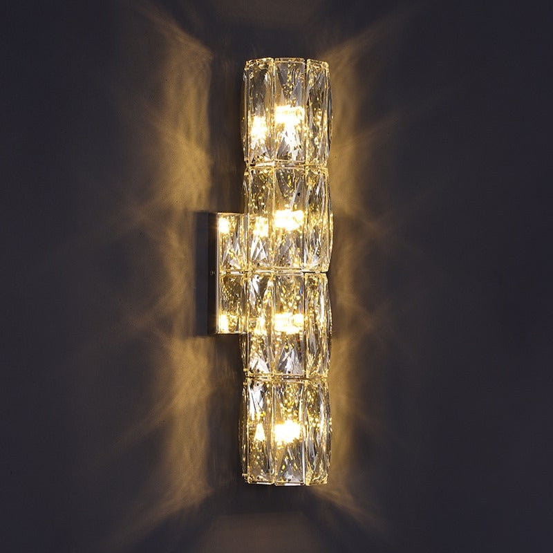 Introducing our Caspian wall light with its elegant styling and golden finish it will be sure to make a stylish addition to any living space. It features an ornate cut glass crystal design encasing the entire light fitting and is complimented by a gold back plate that gives the light an undeniably luxurious style. The crystals hark back to classical design trends, whilst the gold finishes the piece with a more contemporary and even minimalistic twist ideal for any home.