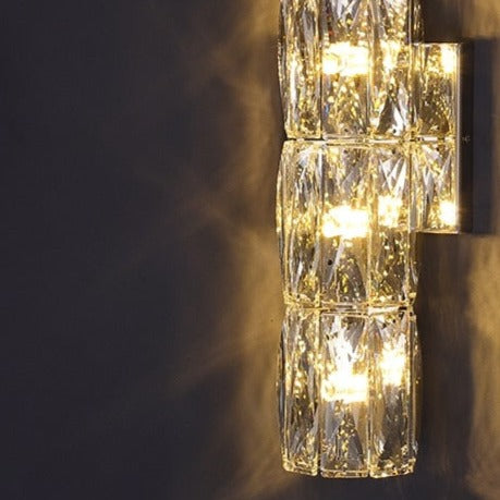 Introducing our Caspian wall light with its elegant styling and golden finish it will be sure to make a stylish addition to any living space. It features an ornate cut glass crystal design encasing the entire light fitting and is complimented by a gold back plate that gives the light an undeniably luxurious style. The crystals hark back to classical design trends, whilst the gold finishes the piece with a more contemporary and even minimalistic twist ideal for any home.