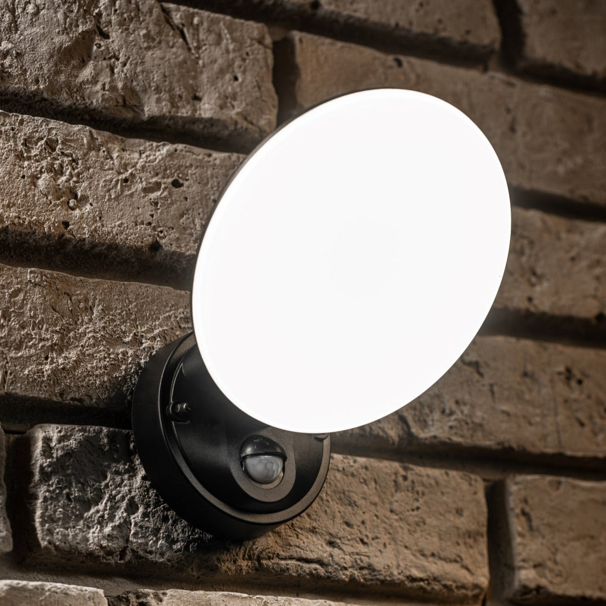 Our EZRA black plastic ABS plastic outdoor wall mounted round outdoor light with built in LED's would look perfect in a modern or more traditional home design. It is designed for durability and longevity with its robust material producing a fully weatherproof and water resistant light fitting. With built in PIR motion sensor