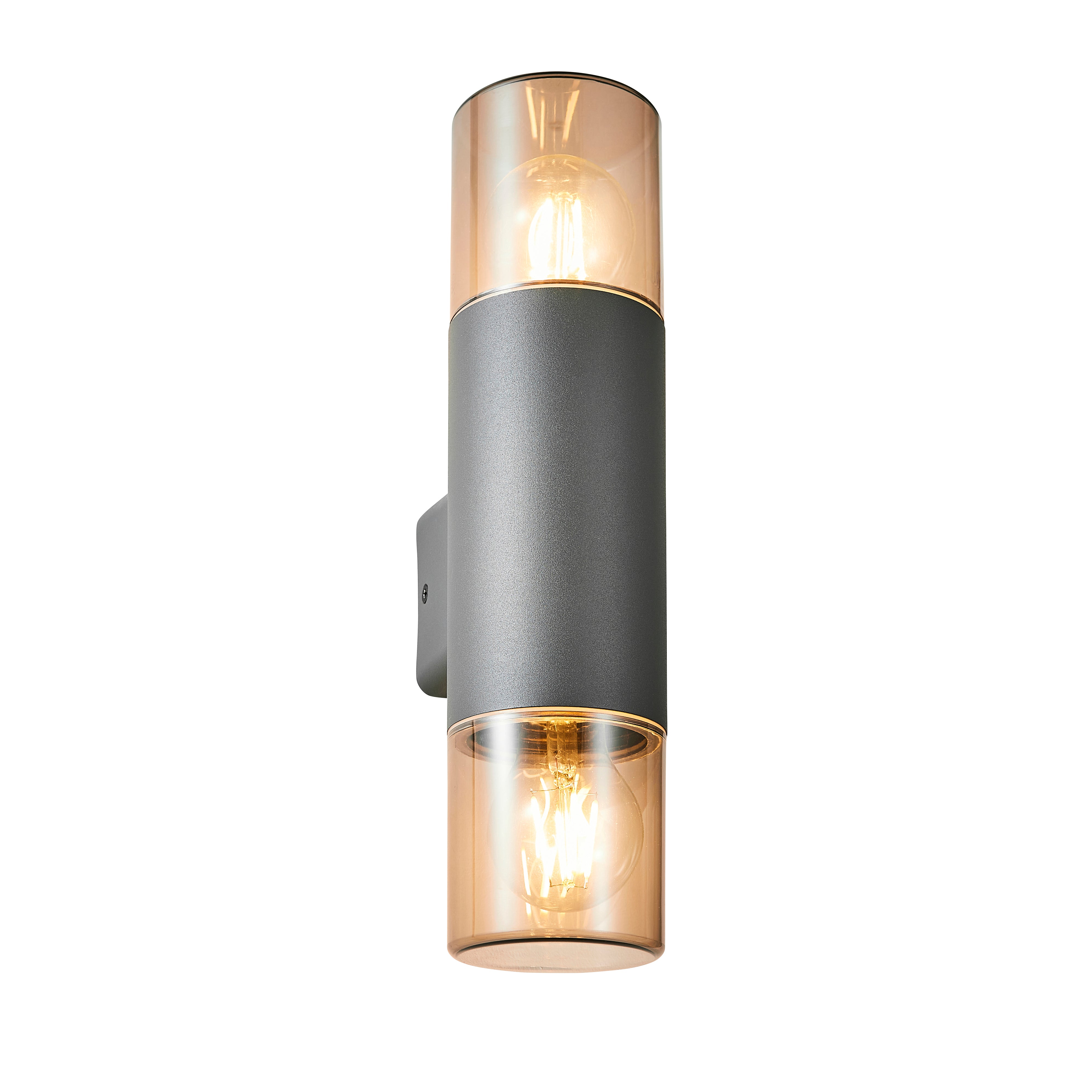 Our Cortez wall light looks great in modern settings. This wall light has a modern round tube design with anthracite finish aluminium body and 2 polycarbonate smoked diffusers. This wall light is perfect for any outdoor space requiring light and security such as gardens, driveways, doorways workspaces, pubs and hotels.