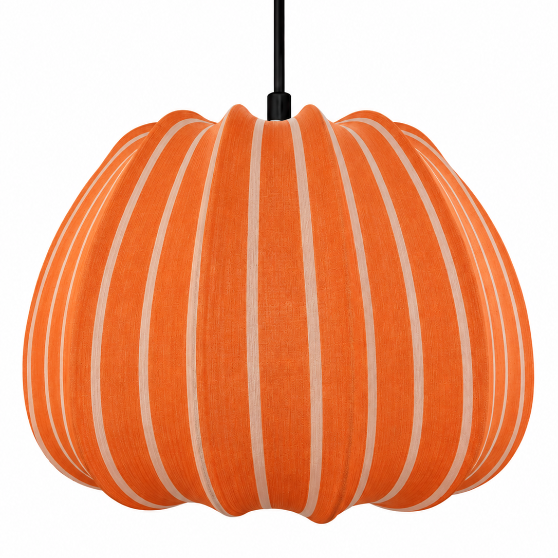 An orange fabric pendant light shaped like a pumpkin, featuring vertical cream-colored stripes and a black hanging cord, shown against a plain white background.