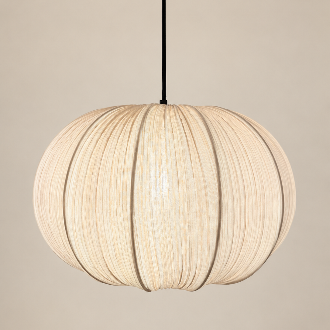A spherical pendant light with a pleated, ribbed beige fabric shade, suspended by a thin black cord against a solid beige background.