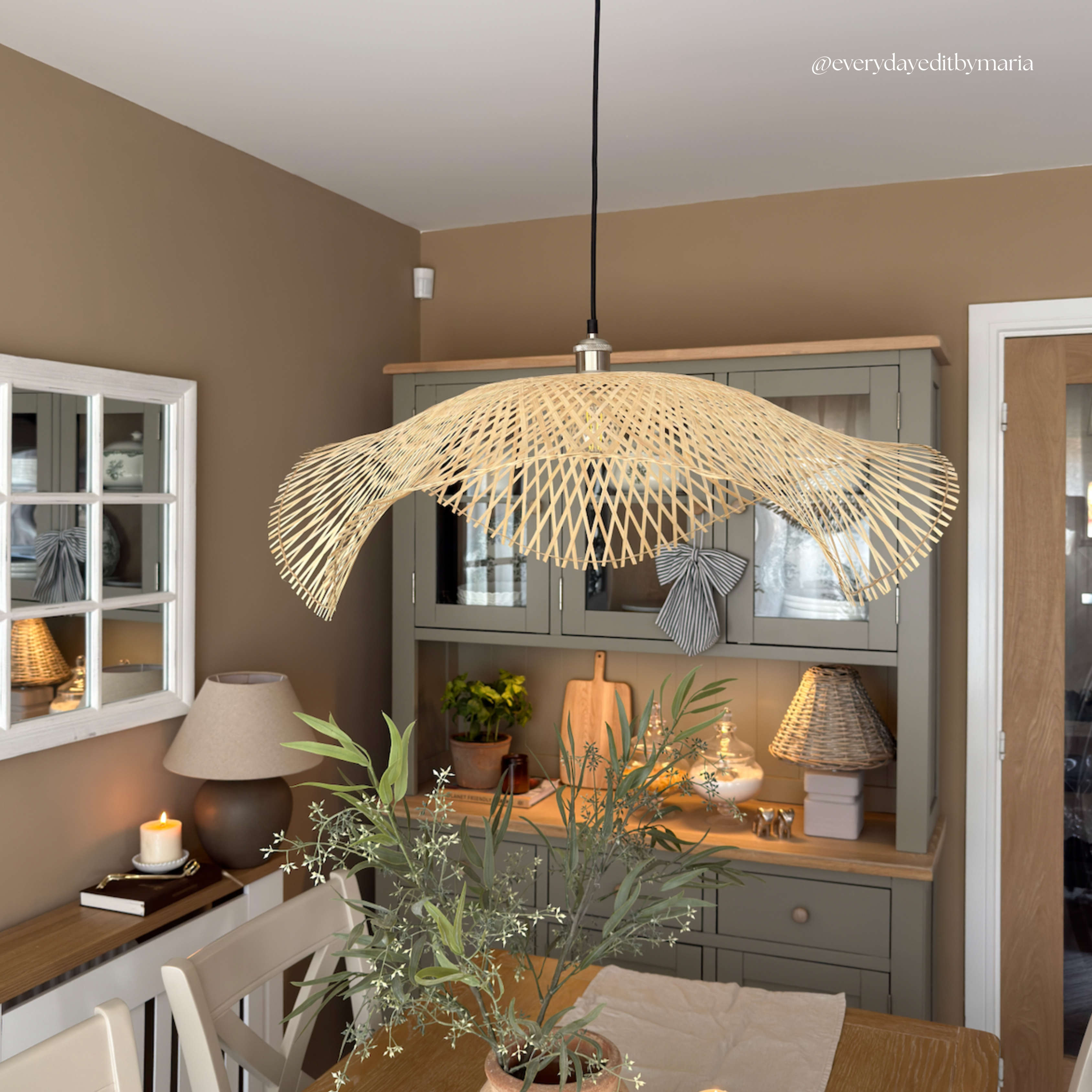 Dining room with a decorative woven pendant light fixture.