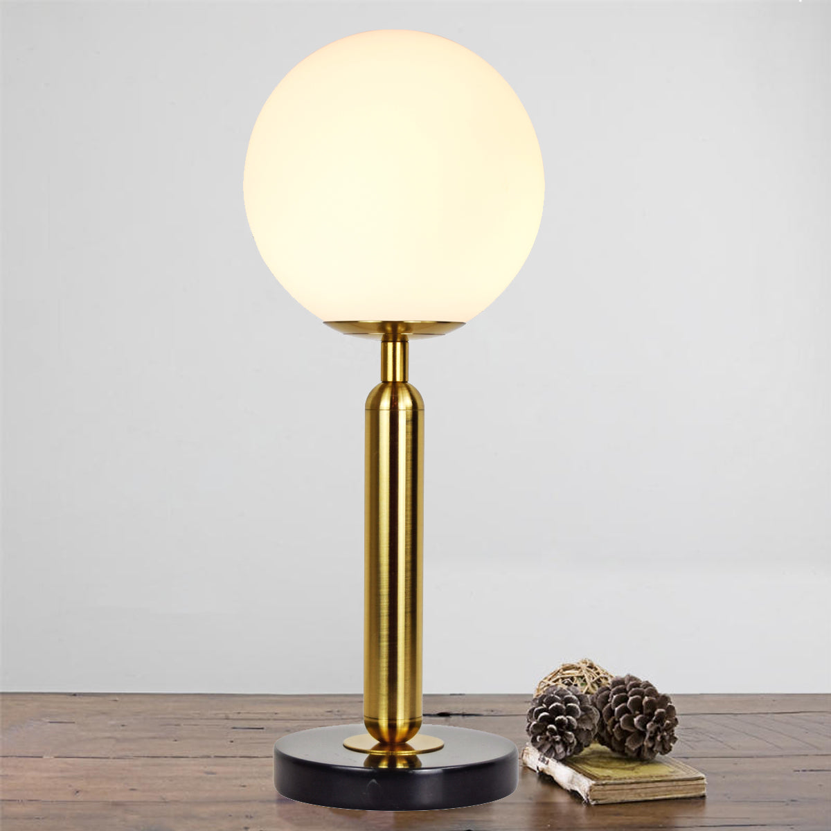 The delicately frosted glass orb makes this table lamp a real statement piece to any room as well as making the most beautiful cloud ambient light.  The frosted glass light bulb is positioned on top of a modern designed marble and brass base, designed to look incredible wherever you choose to show it off.  -