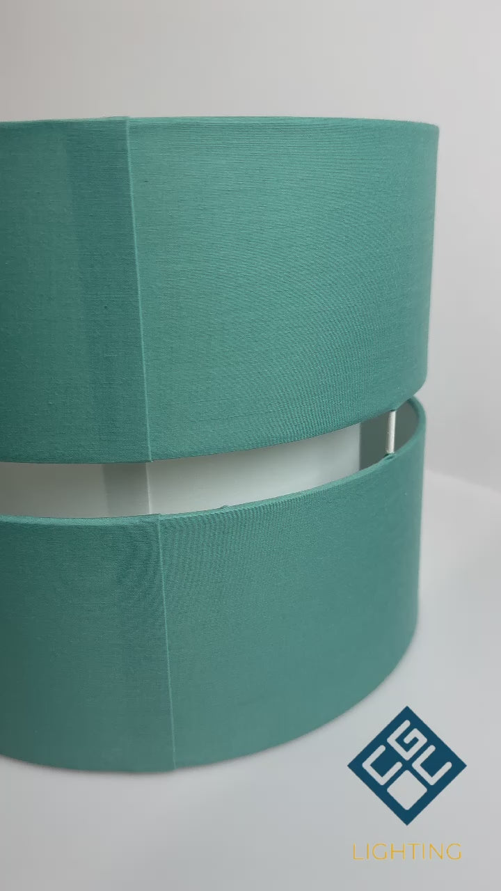 Load video: Our Gayle easy-fit two tiered luxury fabric double layered shade is contemporary in its appearance and we have designed the shade to suit a range of interiors. Easy to fit simply attached to an existing pendant flitting.  It is crafted from high quality fabric material in two layers and complimented with a white inner which looks beautiful when light shines through. The shade has been made to fit both a ceiling light or lamp base.