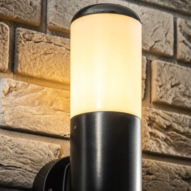 Our Humera black wall mounted round cylinder outdoor light would look perfect in a modern or more traditional home design. Outside wall lights can provide atmospheric light in your garden, at the front door or on the terrace as well as a great security solution. It is designed for durability and longevity with its robust material producing a fully weatherproof and water resistant light fitting.