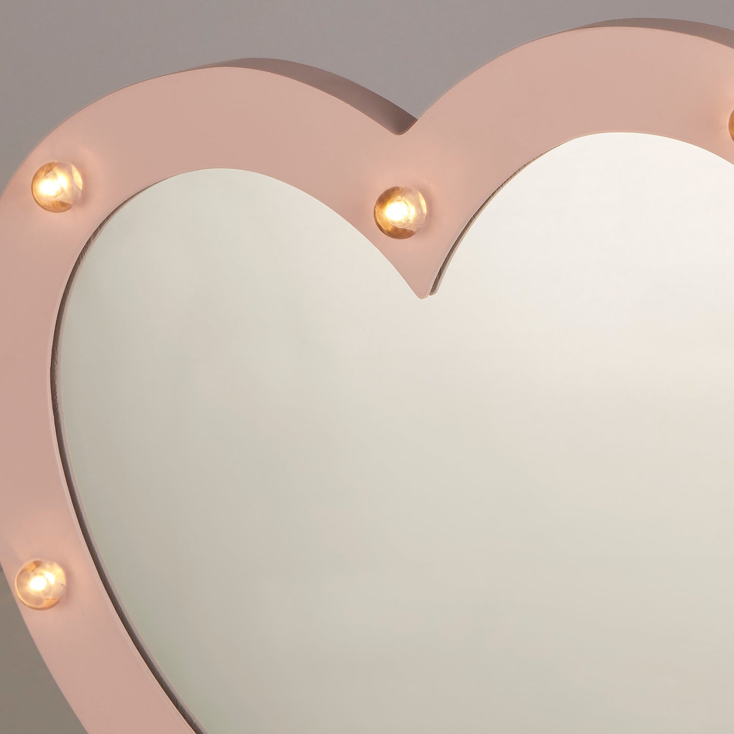 The Amore wooden pink love heart mirror with built in led hollywood style bulbs is perfect to add style and elegance to any room. A great finishing touch to any girls bedroom or dressing room. This mirror light is battery operated so no installation is required simply attached to a wall or the desired surface. Easy to access on/off switch is at the side making this light the perfect addition.  