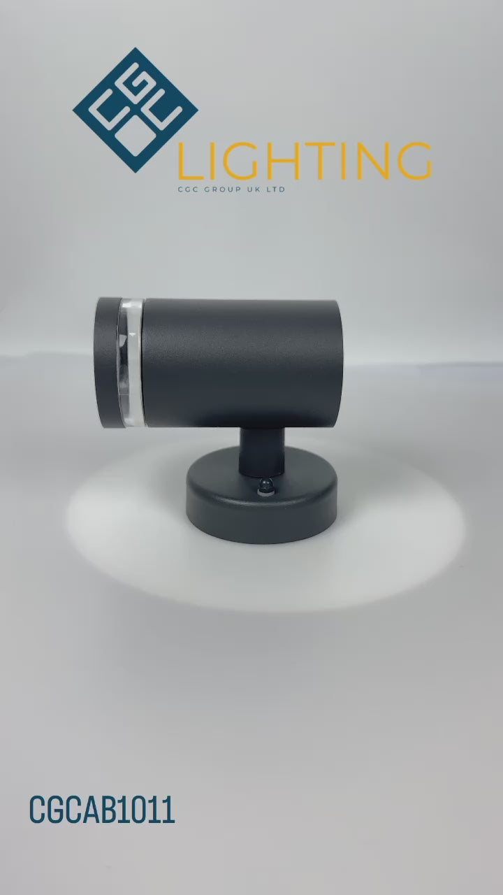 Load video: Our Jennifer dark grey outdoor wall mounted cylinder single spot outdoor light would look perfect in a modern or more traditional home design. Outside wall lights can provide atmospheric light in your garden, at the front door or on the terrace as well as a great security solution. It is designed for durability and longevity with its robust material producing a fully weatherproof and water resistant light fitting.